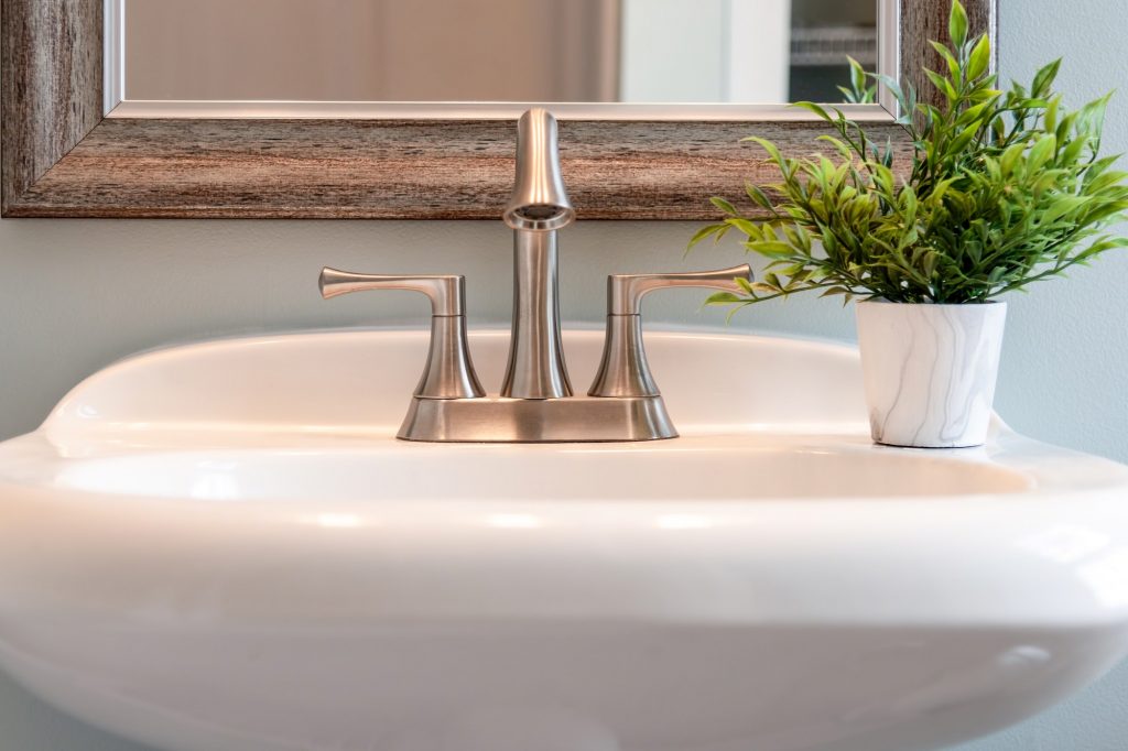 Bathroom sink with brushed nickel faucet